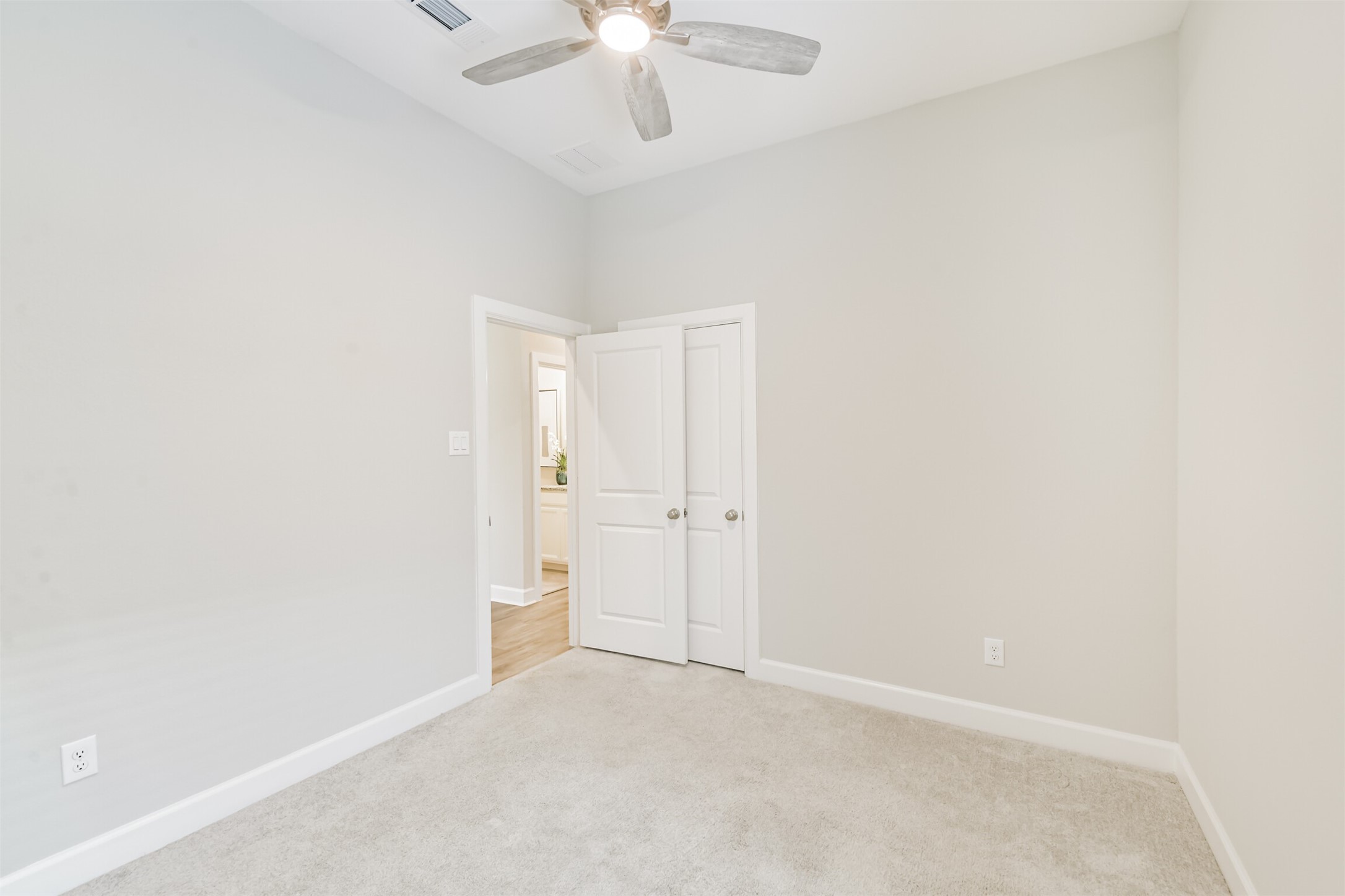 15611 Rising Wren Court Conroe, TX 77302 - Photo 36 of 38 an empty room with a chandelier fan and closet