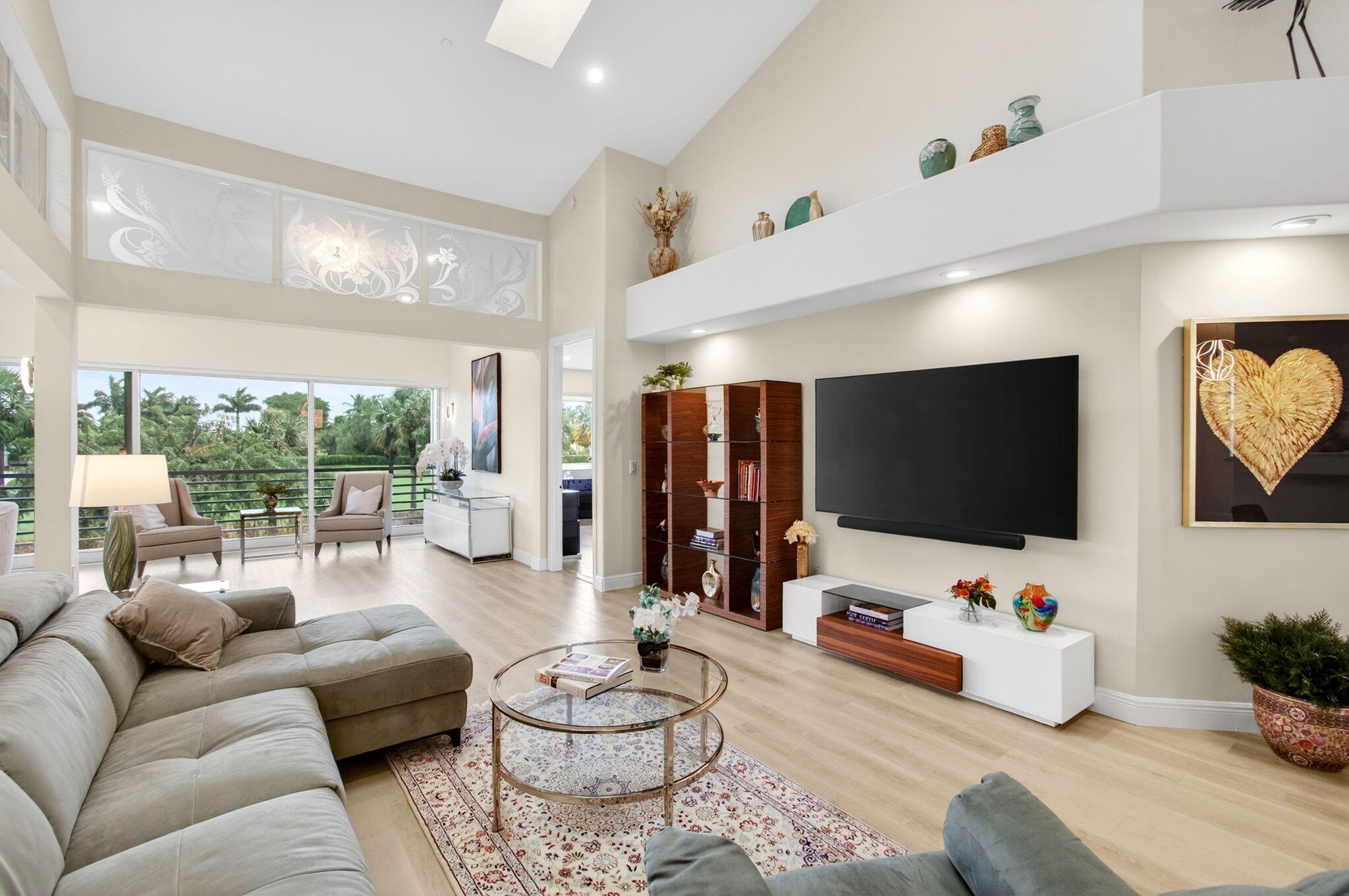 2530 Coco Plum Boulevard, Unit 1002 Boca Raton, FL 33496 - Photo 13 of 61 a living room with furniture and a flat screen tv