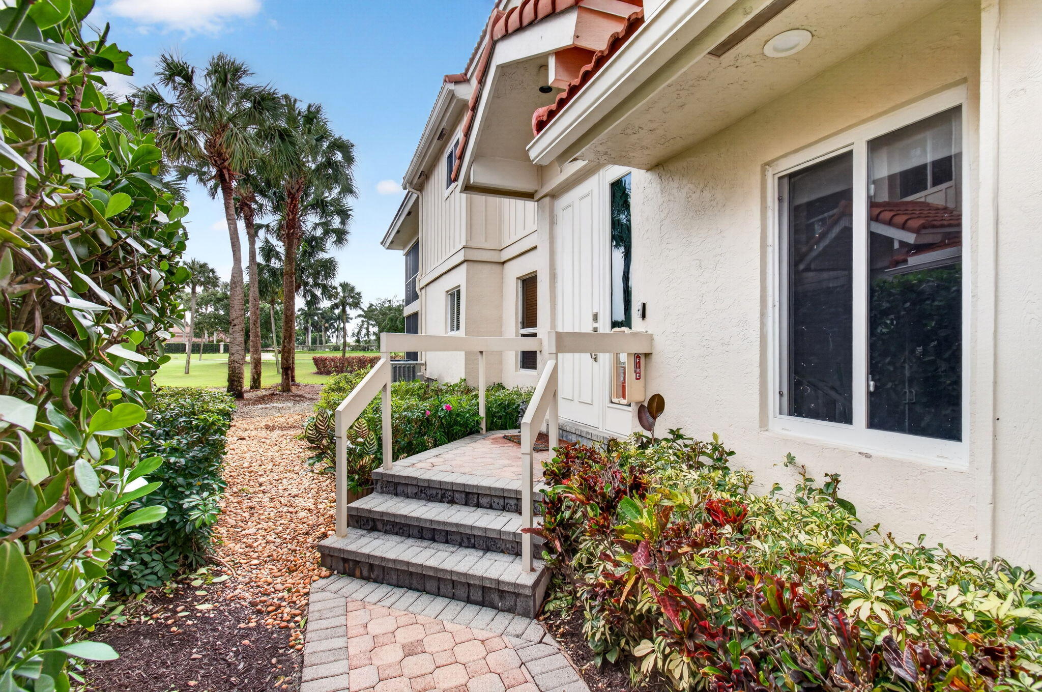 2530 Coco Plum Boulevard, Unit 1002 Boca Raton, FL 33496 - Photo 2 of 61 a view of a house with a yard and garden