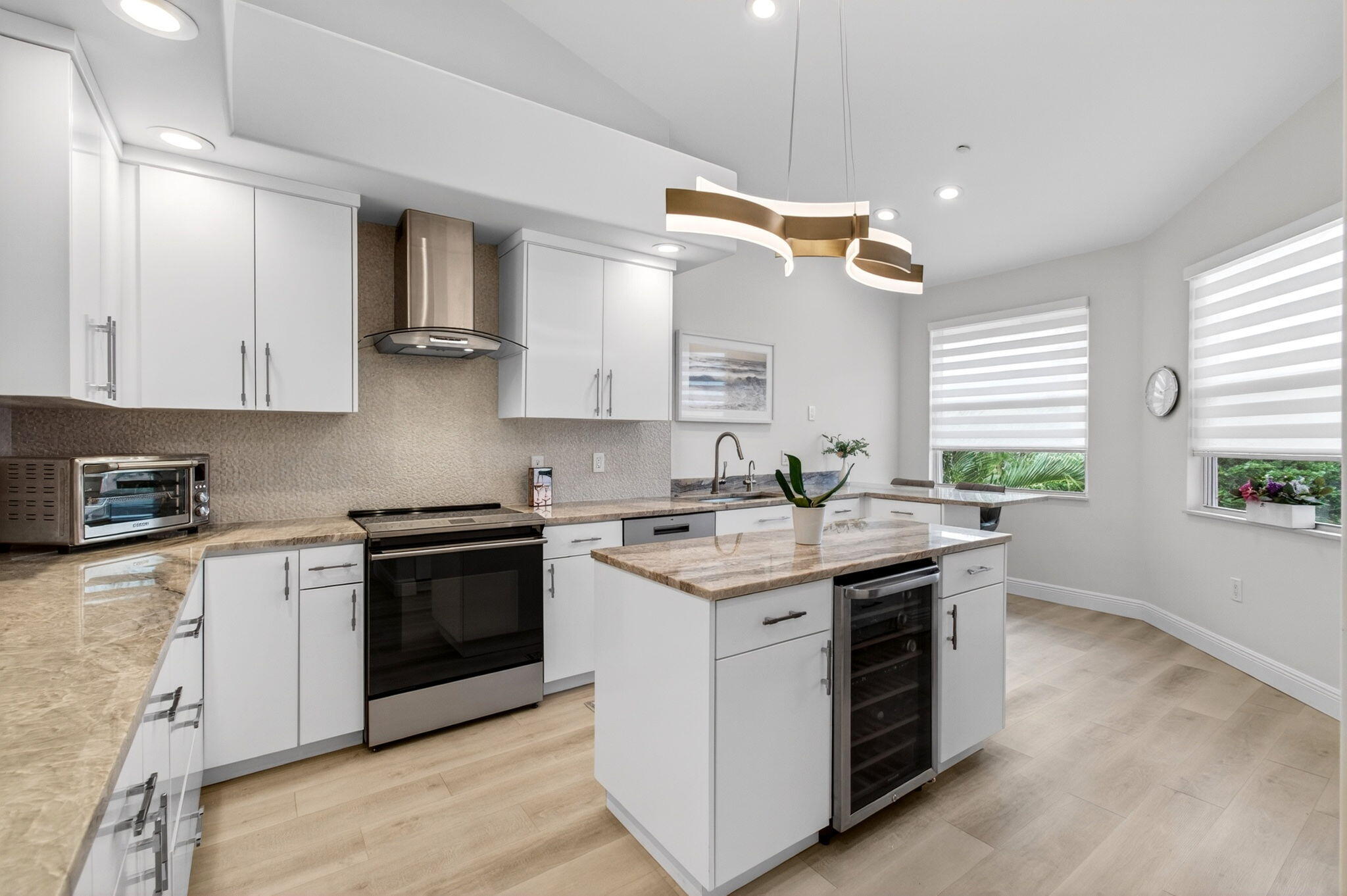2530 Coco Plum Boulevard, Unit 1002 Boca Raton, FL 33496 - Photo 22 of 61 a kitchen with a stove and a sink