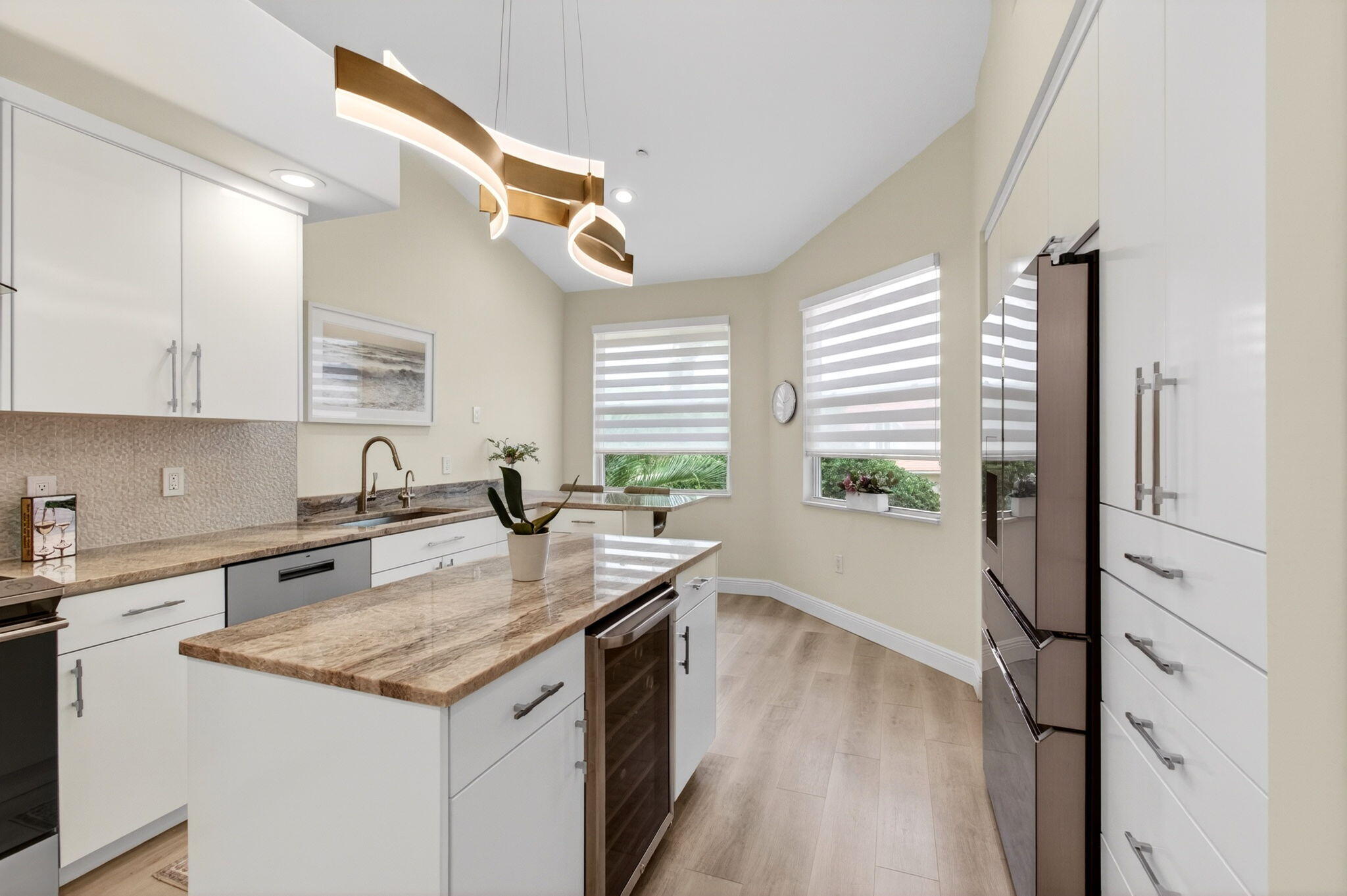 2530 Coco Plum Boulevard, Unit 1002 Boca Raton, FL 33496 - Photo 24 of 61 a kitchen with granite countertop a sink and a refrigerator