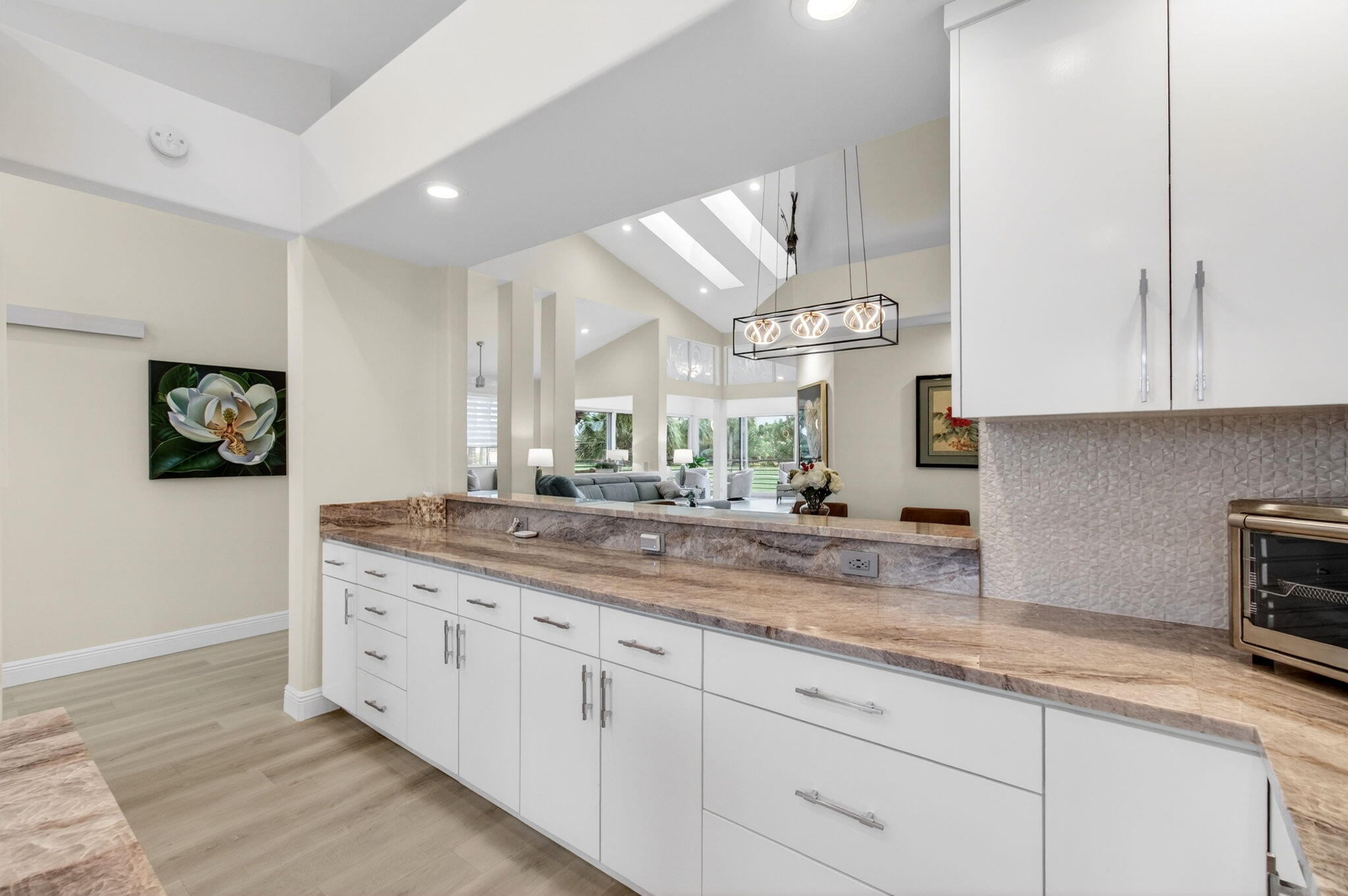 2530 Coco Plum Boulevard, Unit 1002 Boca Raton, FL 33496 - Photo 27 of 61 a kitchen with stainless steel appliances granite countertop a sink and a white cabinets