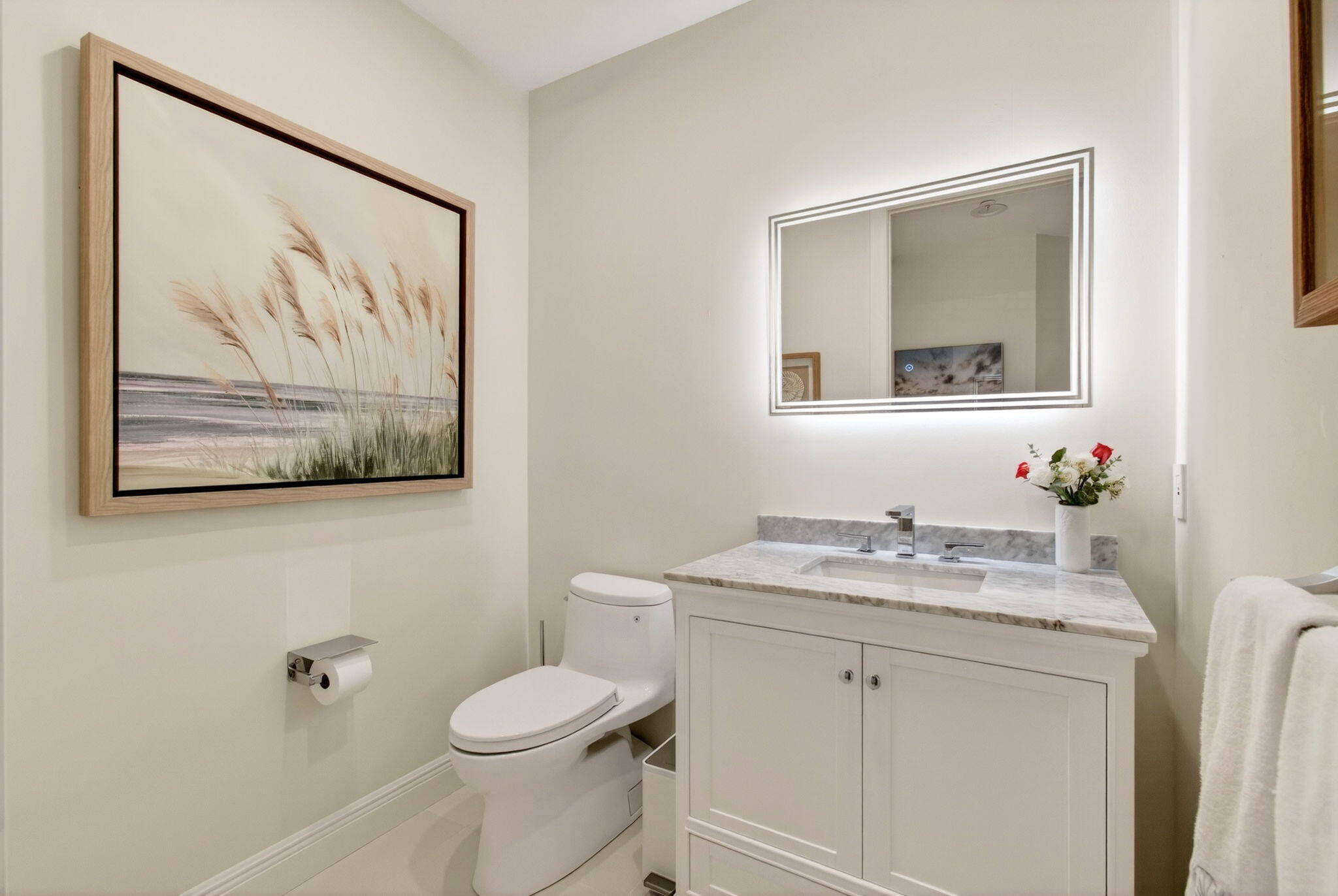 2530 Coco Plum Boulevard, Unit 1002 Boca Raton, FL 33496 - Photo 29 of 61 a bathroom with a toilet a sink and mirror