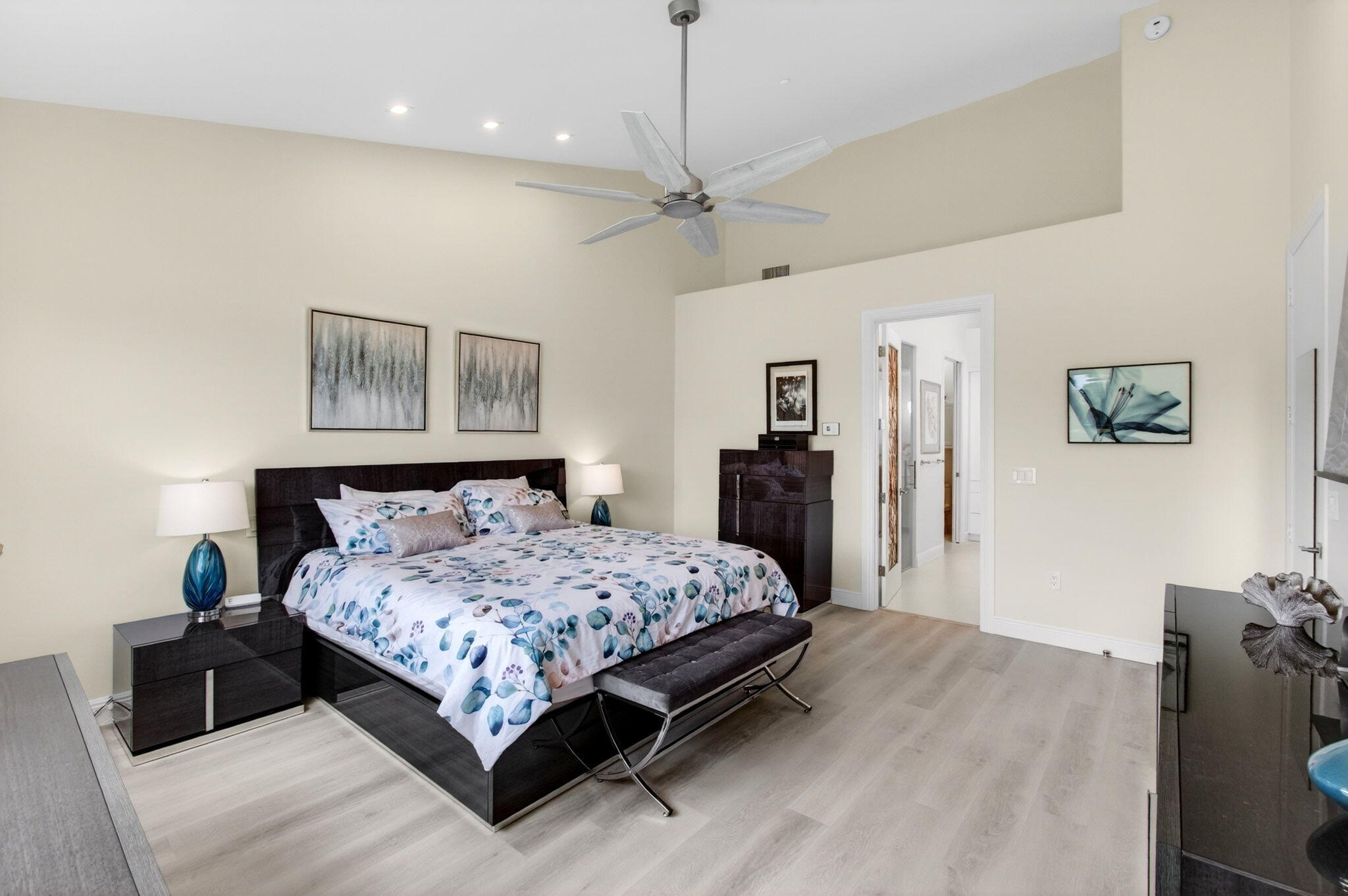 2530 Coco Plum Boulevard, Unit 1002 Boca Raton, FL 33496 - Photo 32 of 61 a bedroom with a large bed and a chandelier