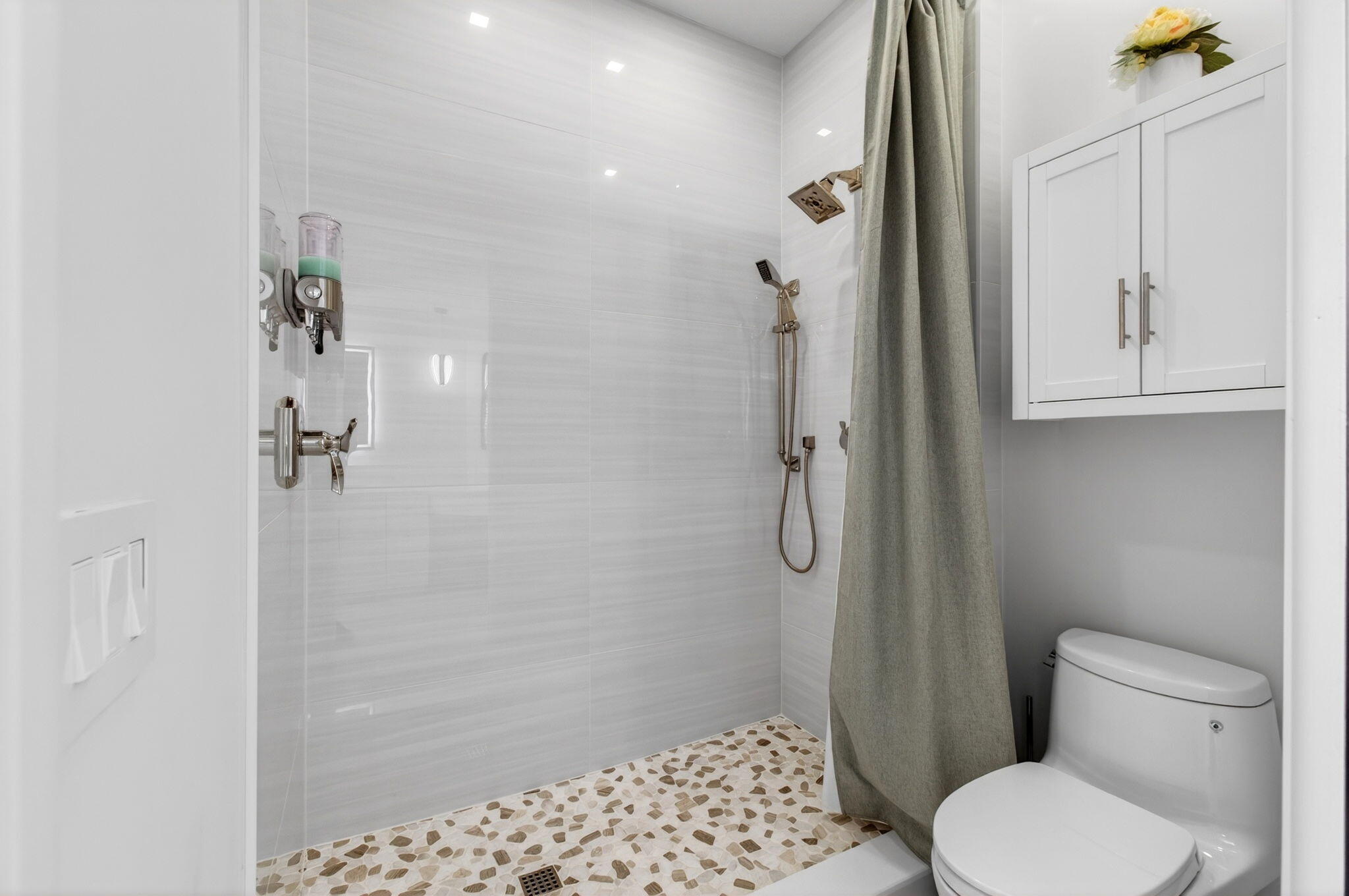2530 Coco Plum Boulevard, Unit 1002 Boca Raton, FL 33496 - Photo 35 of 61 a bathroom with a toilet and a shower