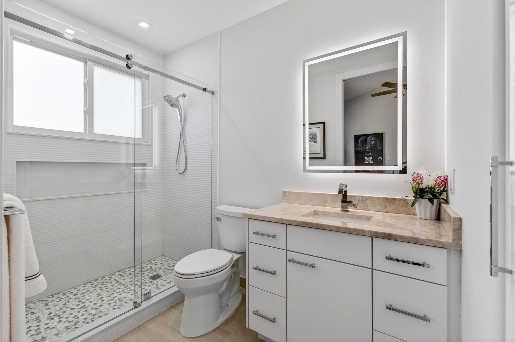 2530 Coco Plum Boulevard, Unit 1002 Boca Raton, FL 33496 - Photo 40 of 61 a bathroom with a granite countertop sink toilet a mirror a vanity and shower