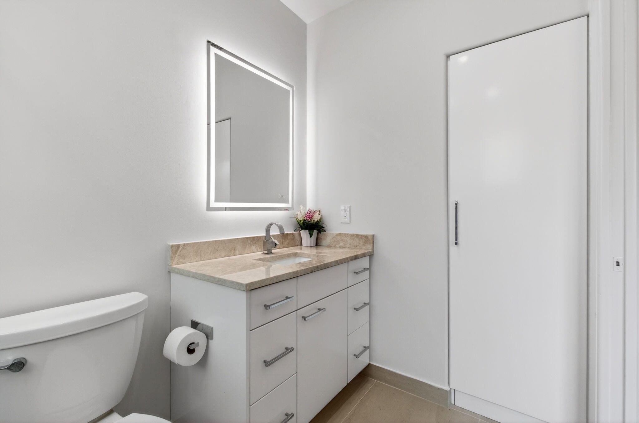 2530 Coco Plum Boulevard, Unit 1002 Boca Raton, FL 33496 - Photo 41 of 61 a bathroom with a granite countertop sink a toilet and a mirror