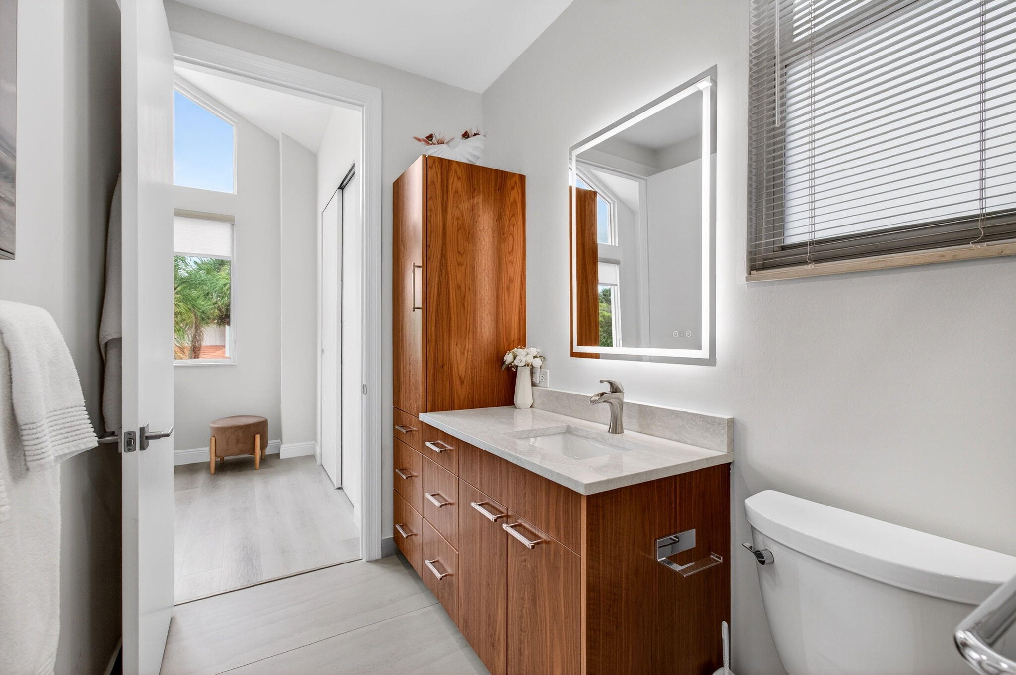 2530 Coco Plum Boulevard, Unit 1002 Boca Raton, FL 33496 - Photo 46 of 61 a bathroom with a sink a toilet and a mirror
