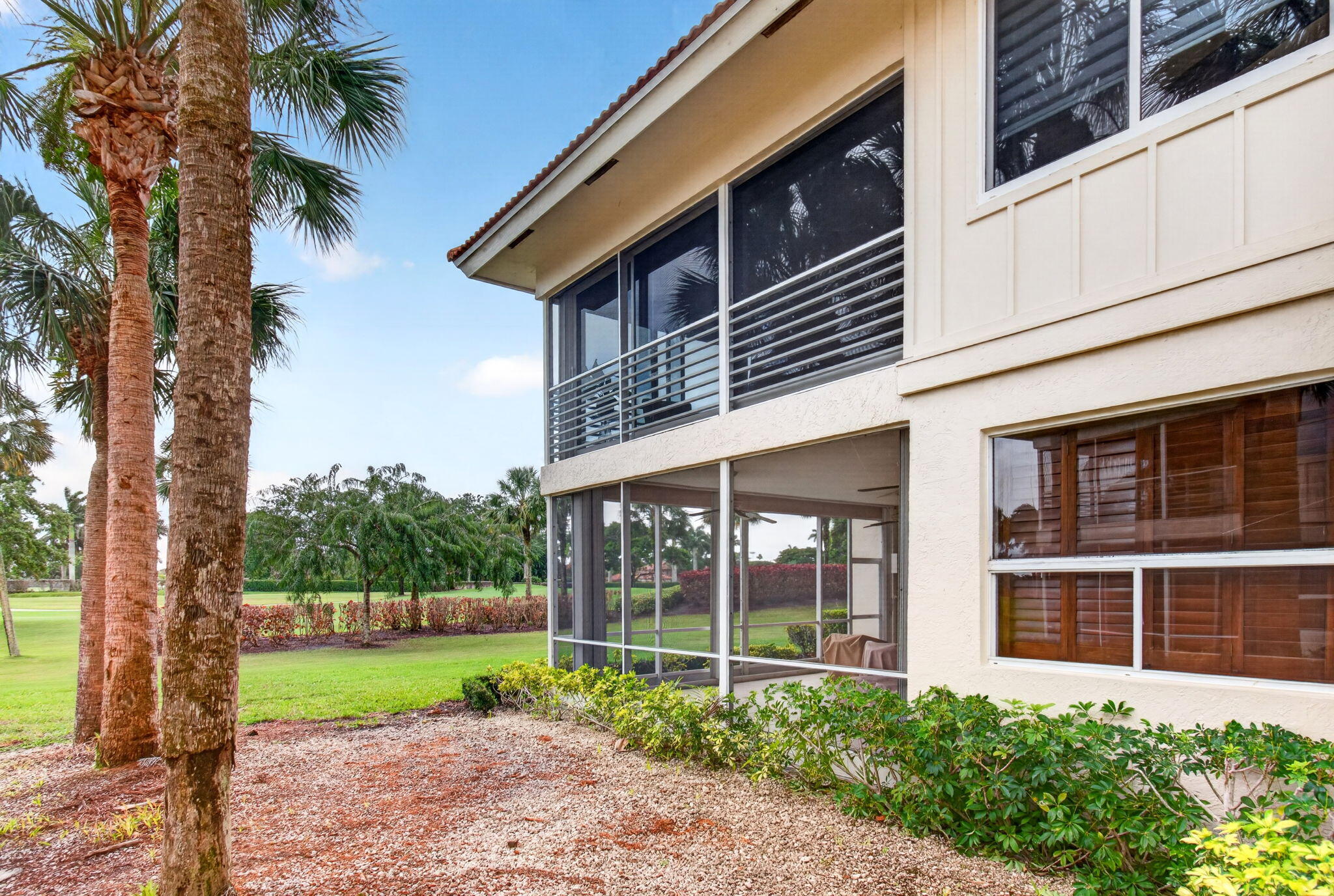 2530 Coco Plum Boulevard, Unit 1002 Boca Raton, FL 33496 - Photo 47 of 61 a view of a house with a yard and large tree