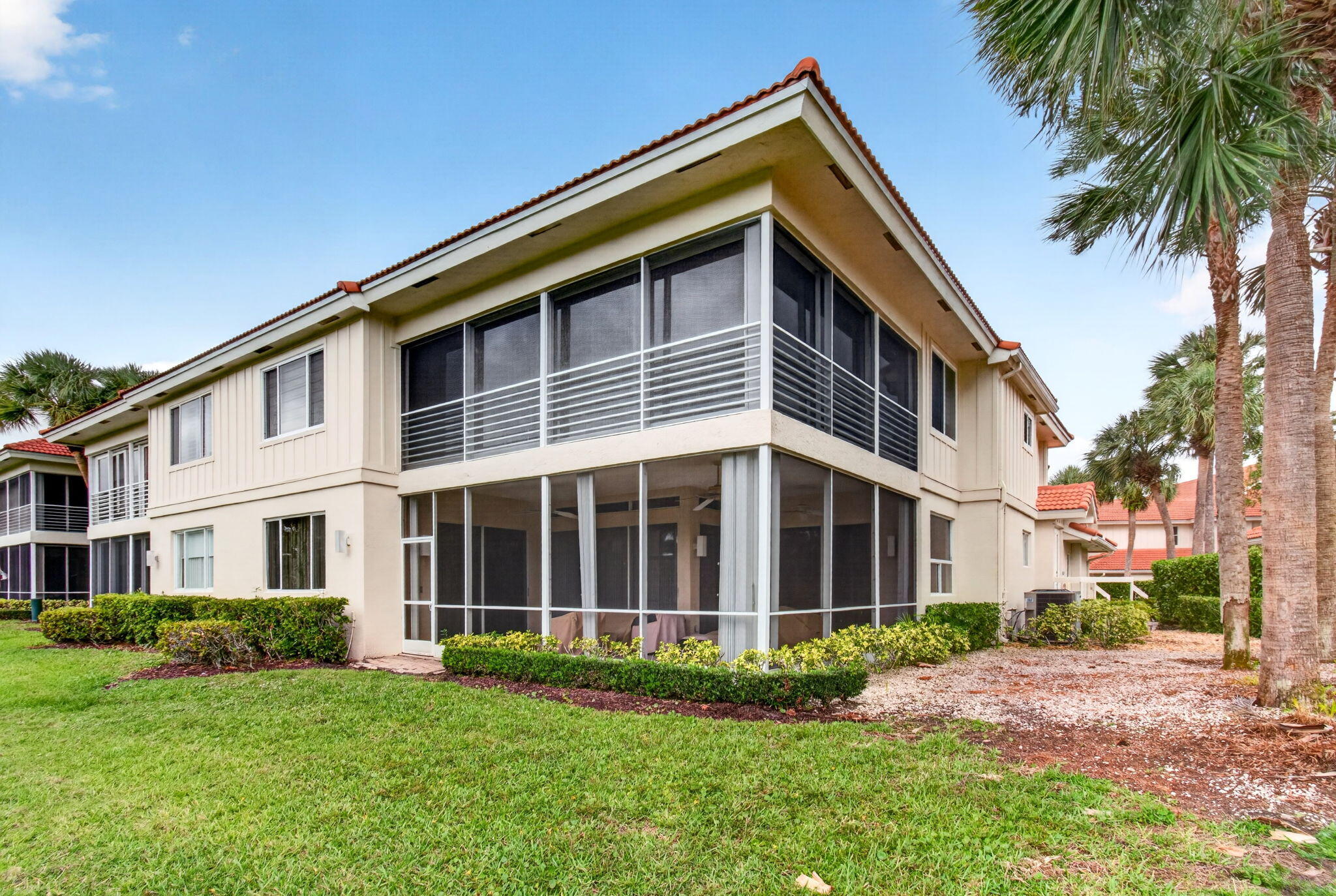 2530 Coco Plum Boulevard, Unit 1002 Boca Raton, FL 33496 - Photo 49 of 61 a front view of a house with a garden