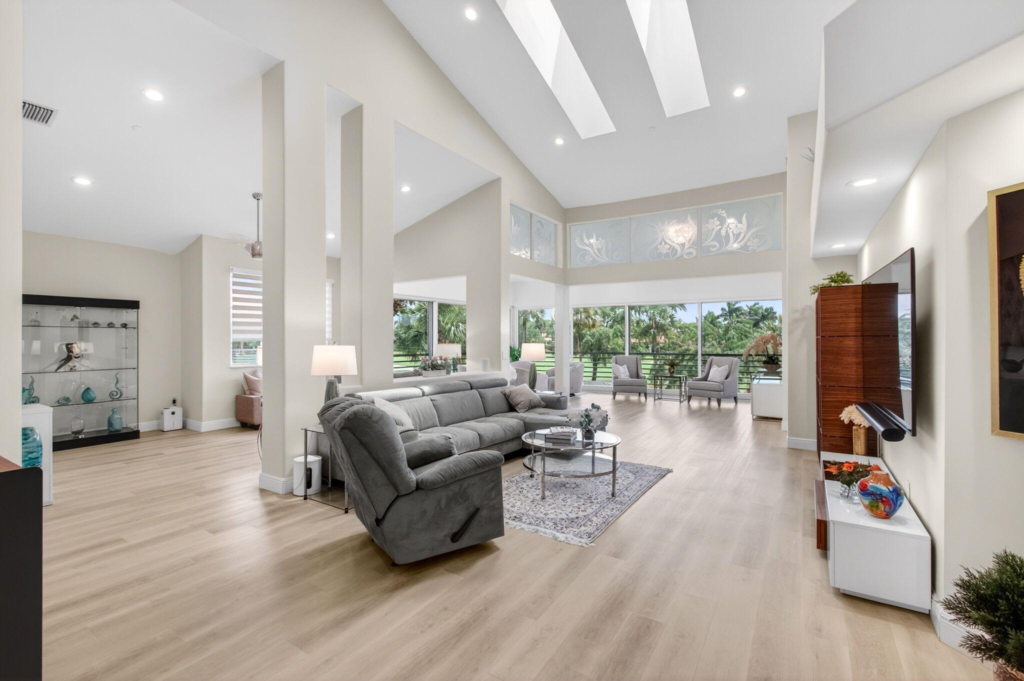 2530 Coco Plum Boulevard, Unit 1002 Boca Raton, FL 33496 - Photo 6 of 61 a living room with furniture fireplace and a large window