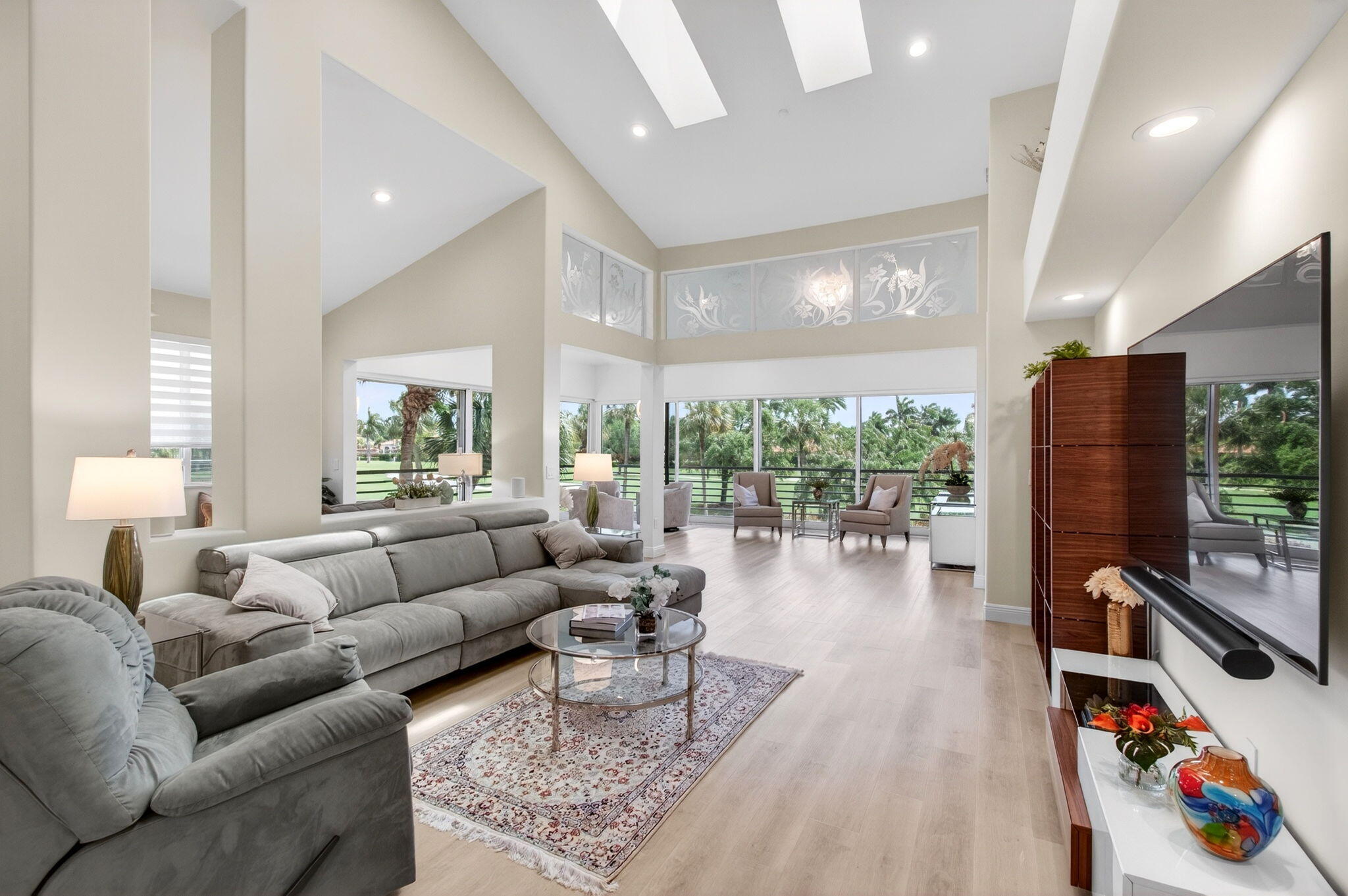 2530 Coco Plum Boulevard, Unit 1002 Boca Raton, FL 33496 - Photo 7 of 61 a living room with furniture and a large window