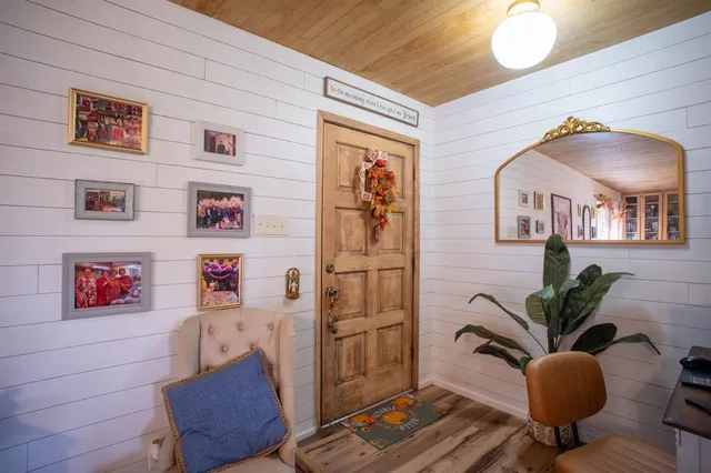 a bedroom with furniture and a flat screen tv