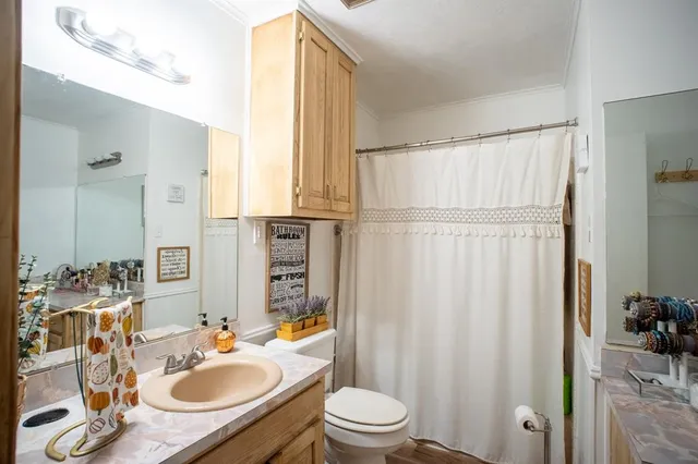 a bathroom with a sink vanity and a mirror