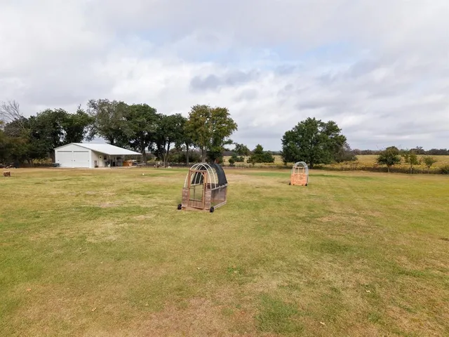 a view of a backyard of a house with a lake view