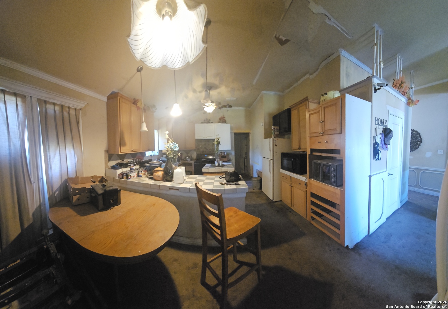 1511 Kayroe Road Adkins, TX 78101 - Photo 5 of 10 a kitchen with stainless steel appliances granite countertop a refrigerator a oven a sink with a dining table and chairs