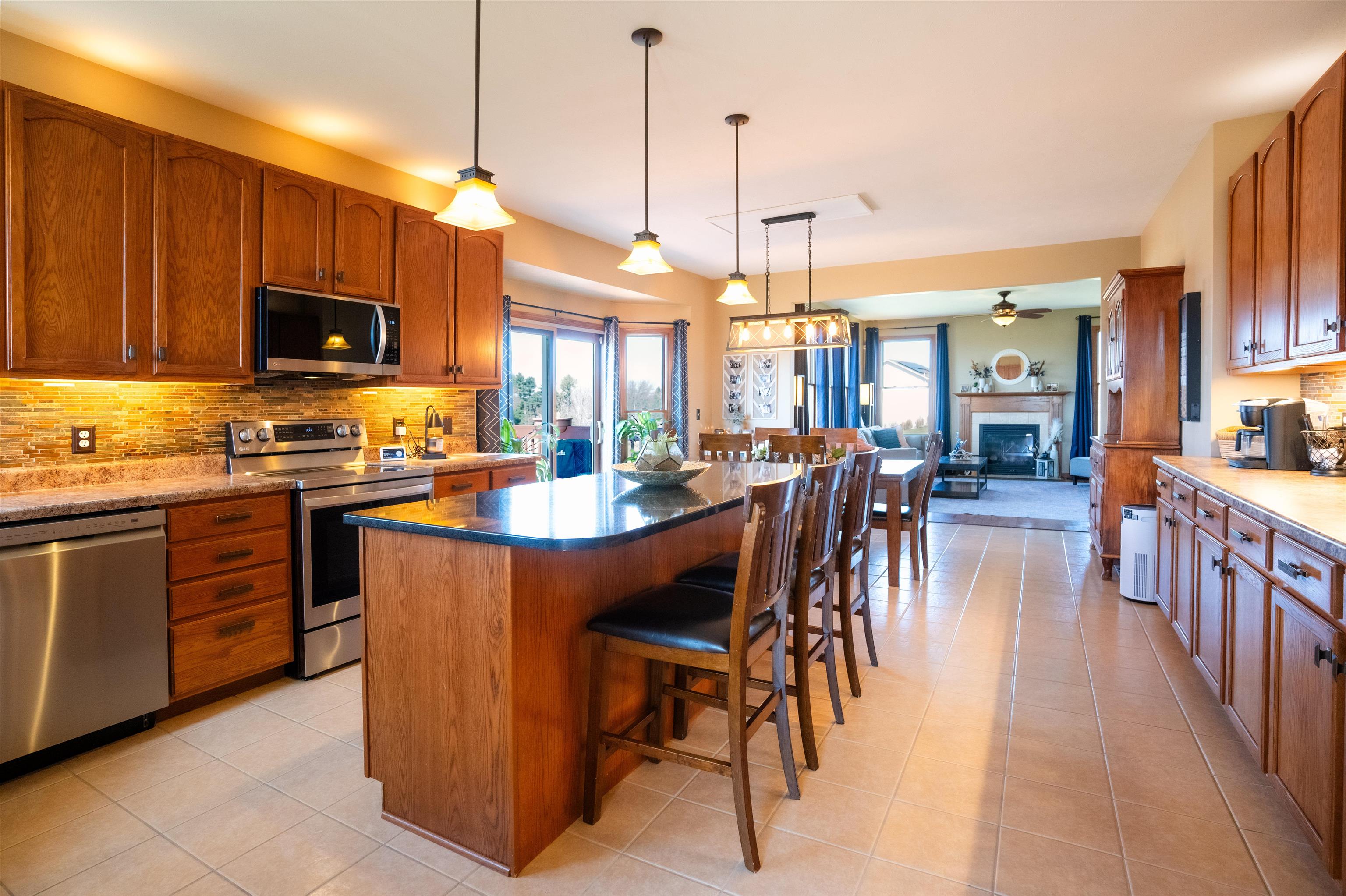 314 Brocket Trail Belvidere, IL 61008 - Photo 16 of 46 a open kitchen with stainless steel appliances granite countertop a stove top oven a sink dishwasher a dining table and chairs with wooden floor