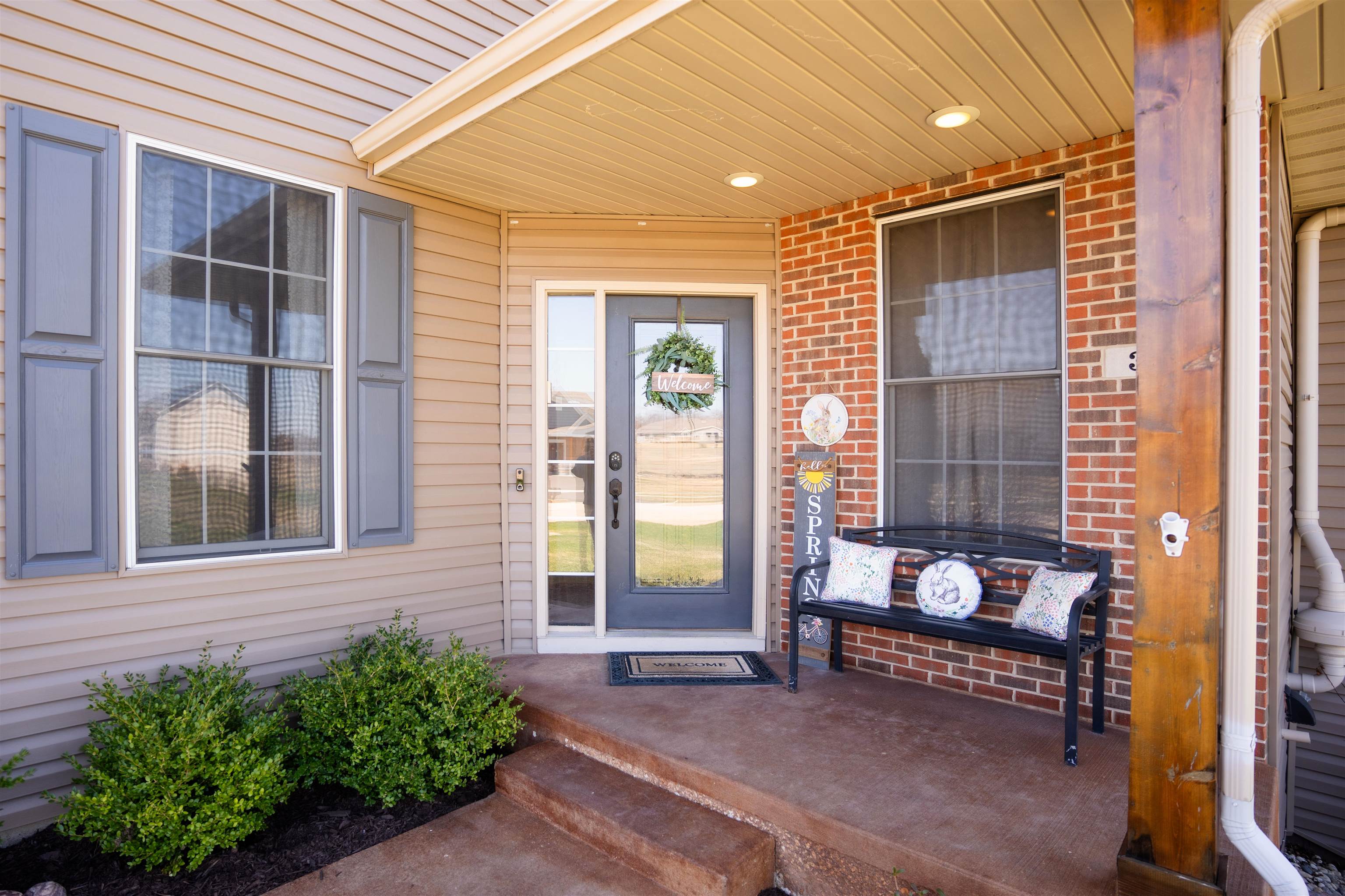 314 Brocket Trail Belvidere, IL 61008 - Photo 5 of 46 a view of a bedroom with a bench and floor to ceiling window and potted plants