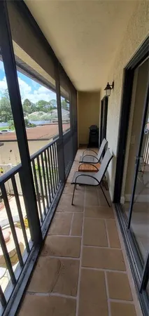 a view of an empty room with furniture and staircase