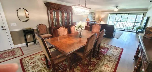 a view of a dining room with furniture window and wooden floor