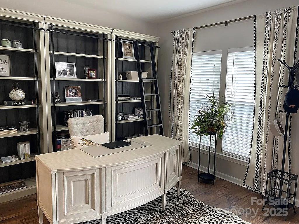 a bedroom with a bed a table and a potted plant