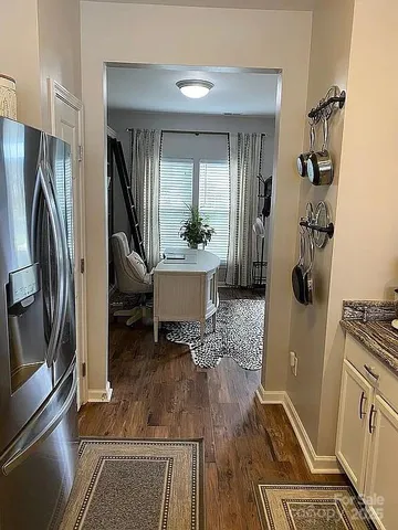 a kitchen with a refrigerator and a stove top oven