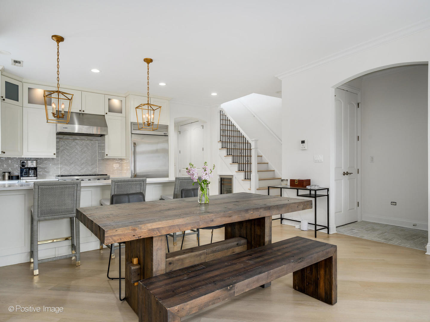 106 South Sangamon Street, Unit 4S Chicago, IL 60607 - Photo 5 of 28 a kitchen with kitchen island stainless steel appliances and wooden cabinets