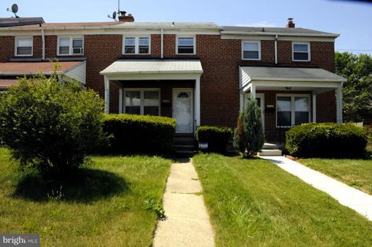 516 Queensgate Road Baltimore, MD 21229 - Photo 1 of 27 a view of a house with potted plants and a yard
