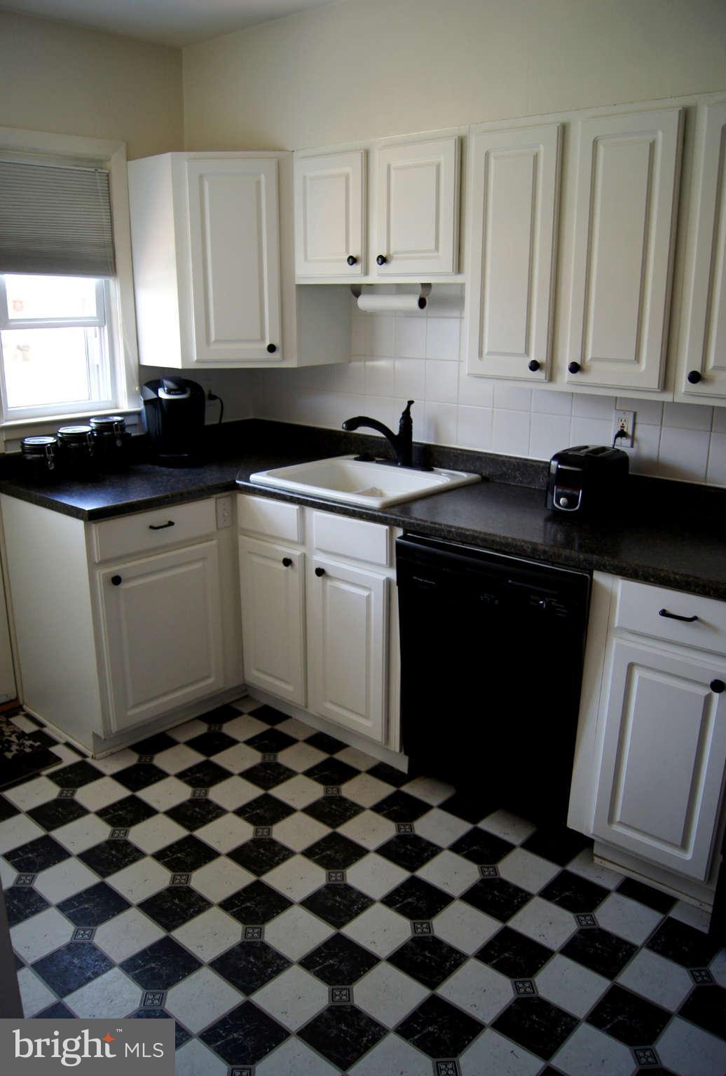 516 Queensgate Road Baltimore, MD 21229 - Photo 18 of 27 a kitchen with a sink a stove and cabinets