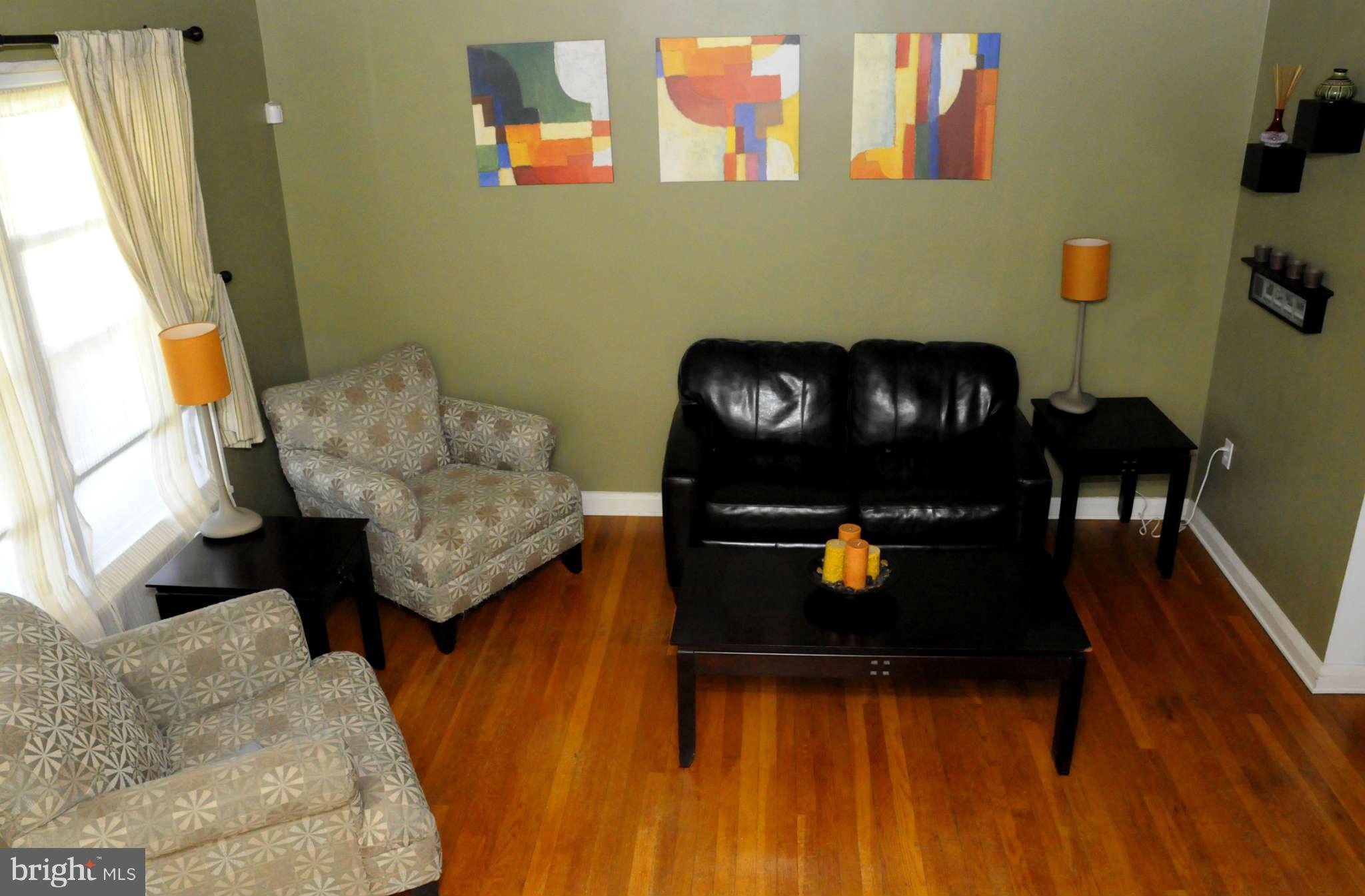 516 Queensgate Road Baltimore, MD 21229 - Photo 3 of 27 a living room with furniture and wooden floor