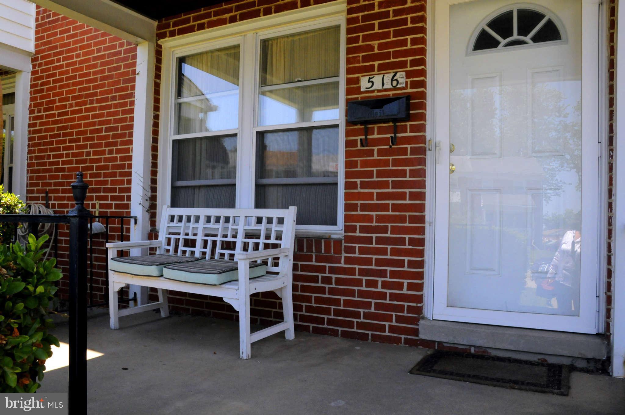 516 Queensgate Road Baltimore, MD 21229 - Photo 24 of 27 a blue bench sitting in front of a building