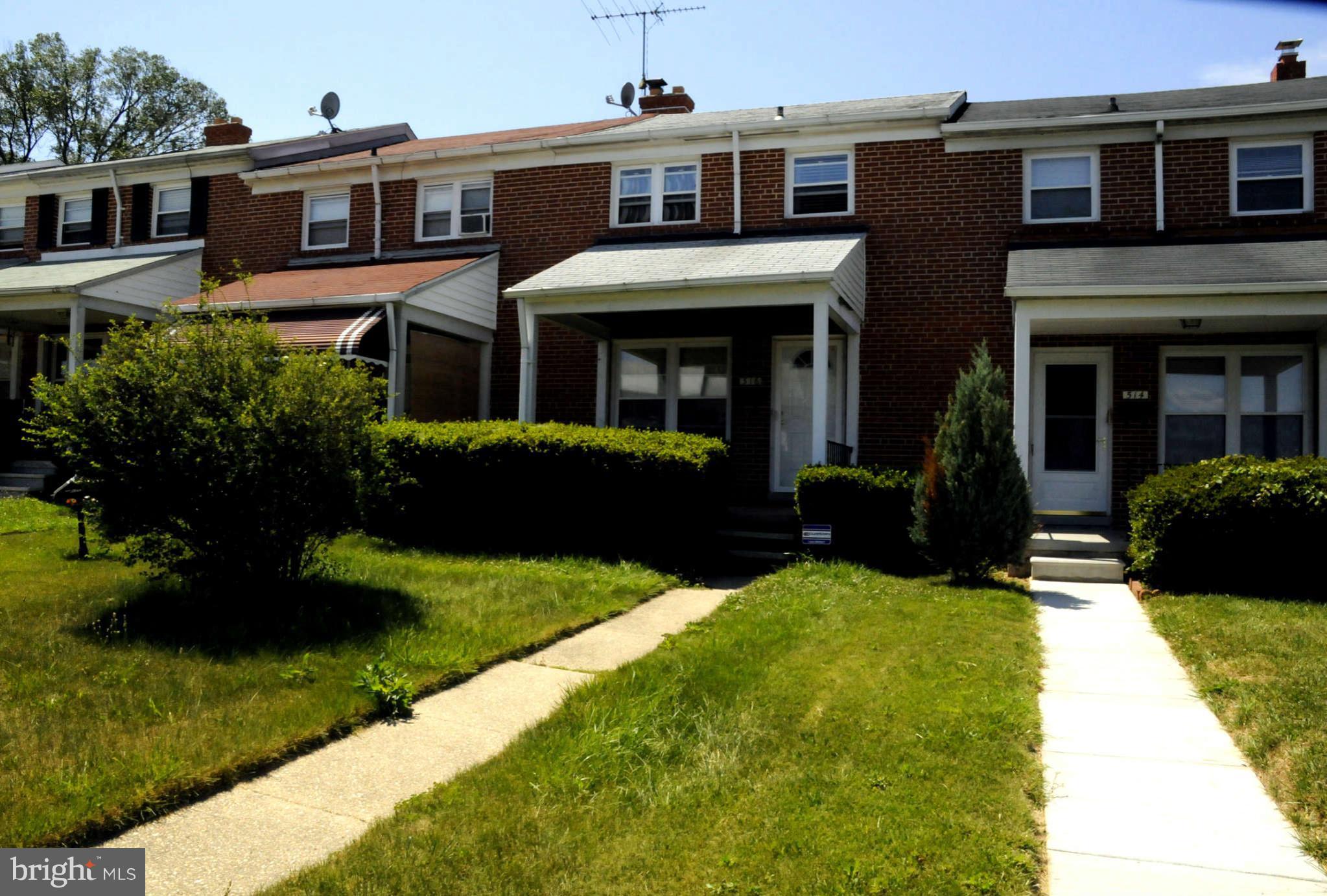 516 Queensgate Road Baltimore, MD 21229 - Photo 25 of 27 a front view of a house with a yard