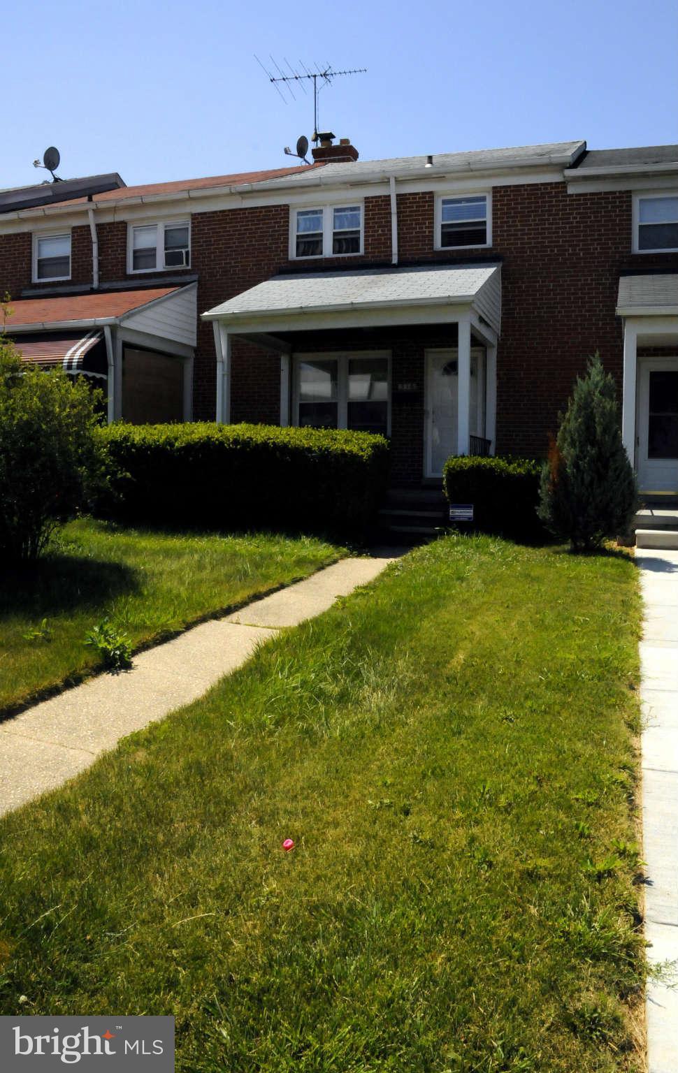 516 Queensgate Road Baltimore, MD 21229 - Photo 26 of 27 a front view of a house with a yard