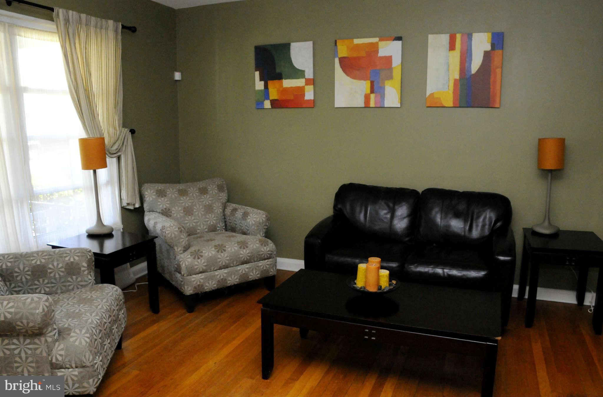 516 Queensgate Road Baltimore, MD 21229 - Photo 4 of 27 a living room with furniture and a window