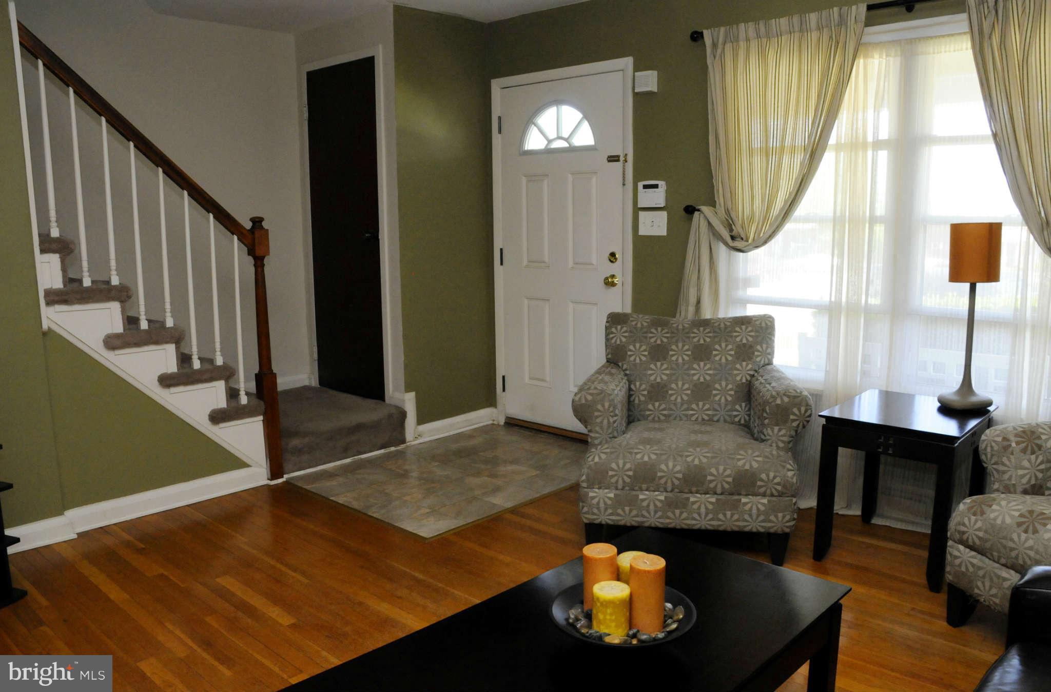 516 Queensgate Road Baltimore, MD 21229 - Photo 5 of 27 a living room with furniture and a fireplace