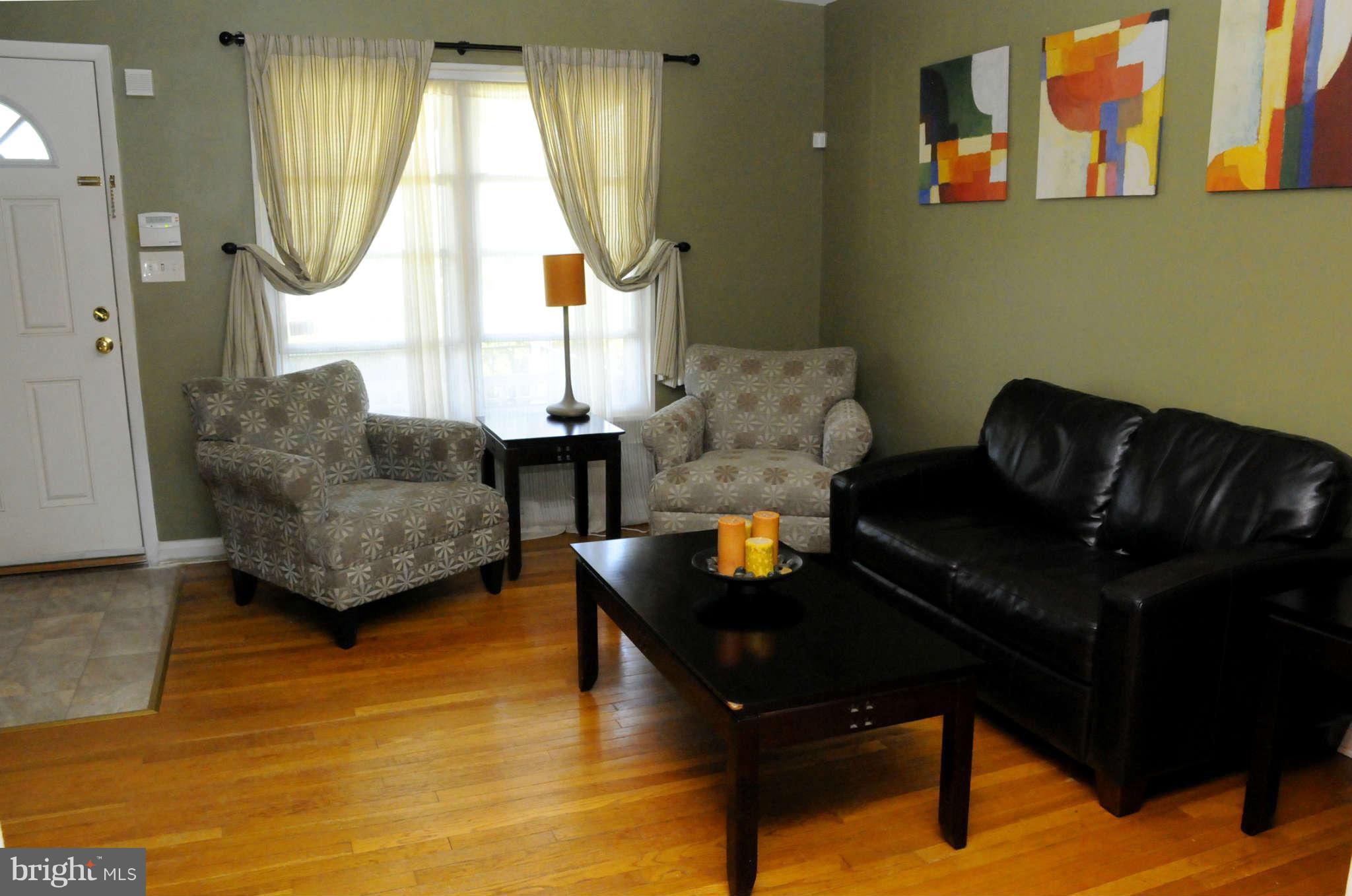 516 Queensgate Road Baltimore, MD 21229 - Photo 6 of 27 a living room with furniture and a window
