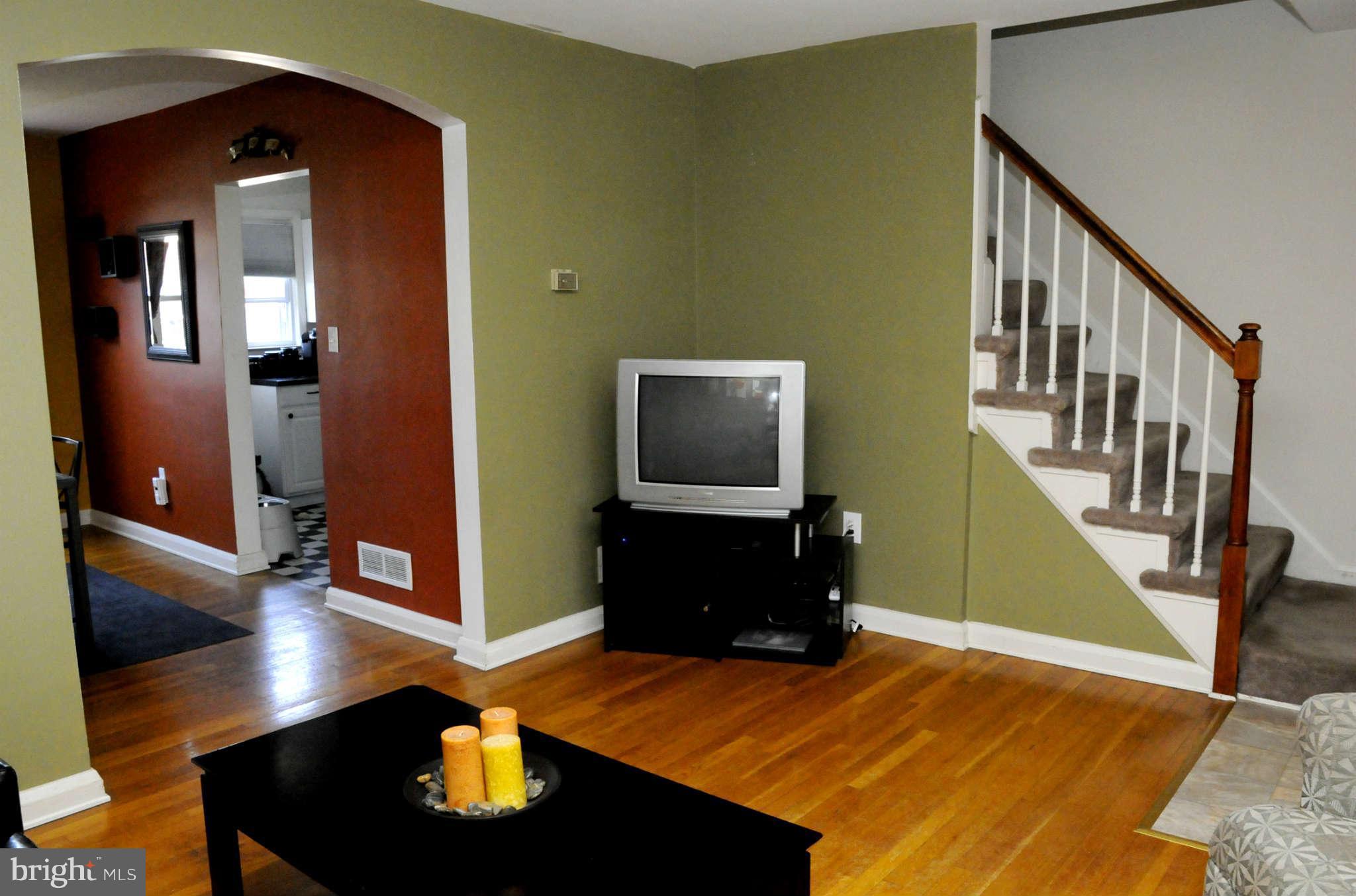 516 Queensgate Road Baltimore, MD 21229 - Photo 8 of 27 a living room with furniture and a flat screen tv