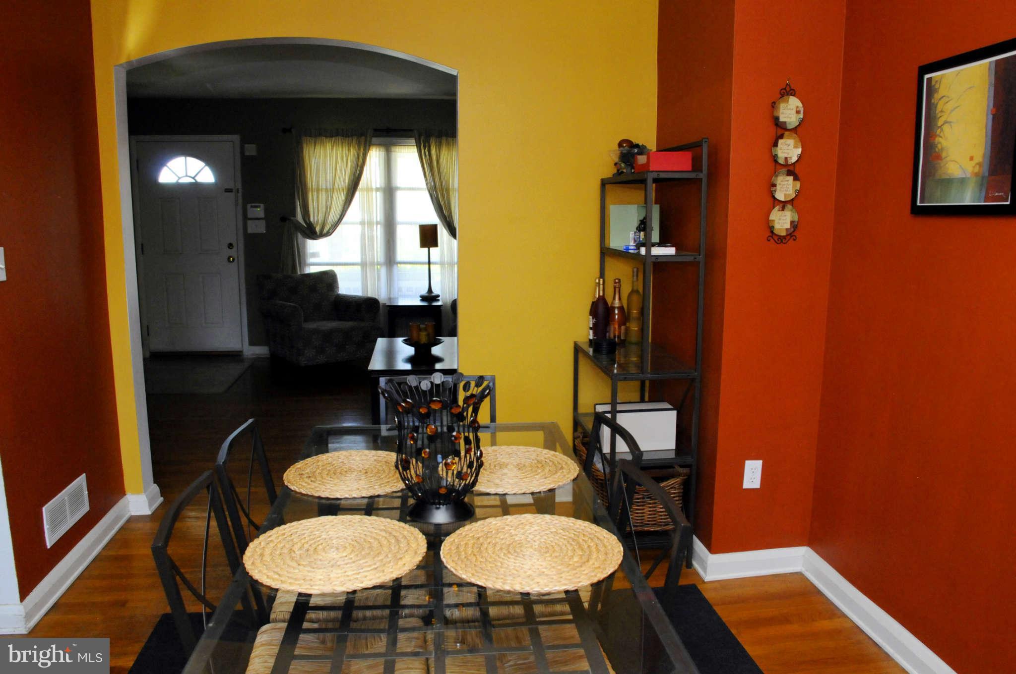 516 Queensgate Road Baltimore, MD 21229 - Photo 10 of 27 a dining room with furniture and wooden floor