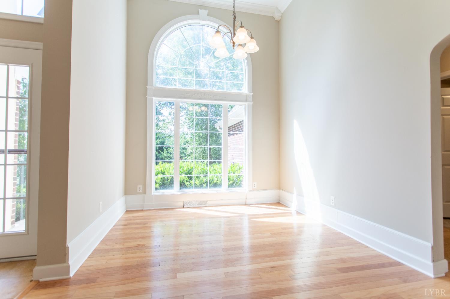549 Thrashers Creek Road Amherst, VA 24521 - Photo 12 of 66 a view of an empty room with wooden floor and a window
