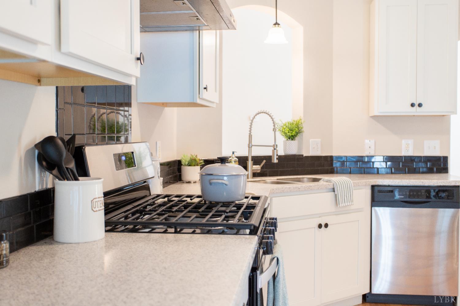 549 Thrashers Creek Road Amherst, VA 24521 - Photo 17 of 66 a kitchen with a sink a stove and white cabinets