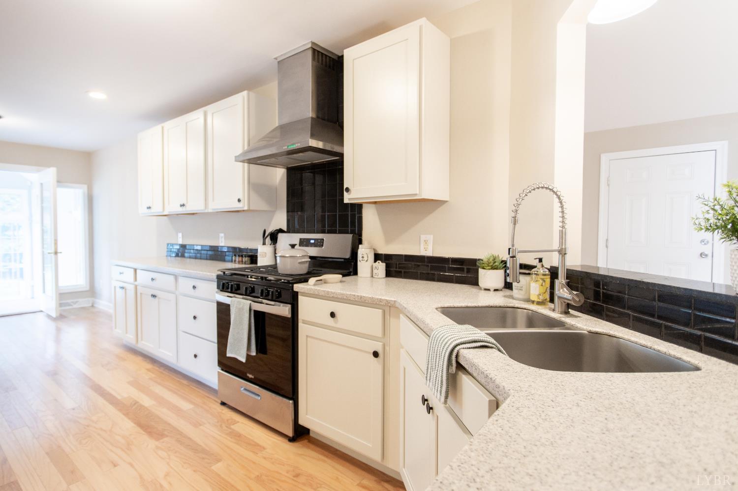 549 Thrashers Creek Road Amherst, VA 24521 - Photo 18 of 66 a kitchen with granite countertop a sink a stove and cabinets