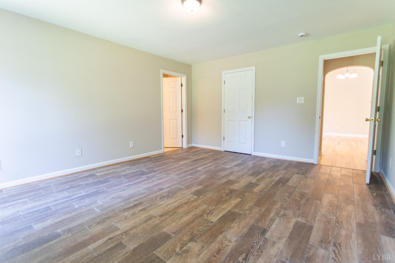 549 Thrashers Creek Road Amherst, VA 24521 - Photo 27 of 66 a view of an empty room and wooden floor