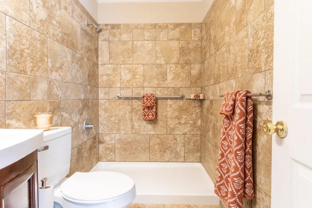 a bathroom with a sink mirror toilet and shower