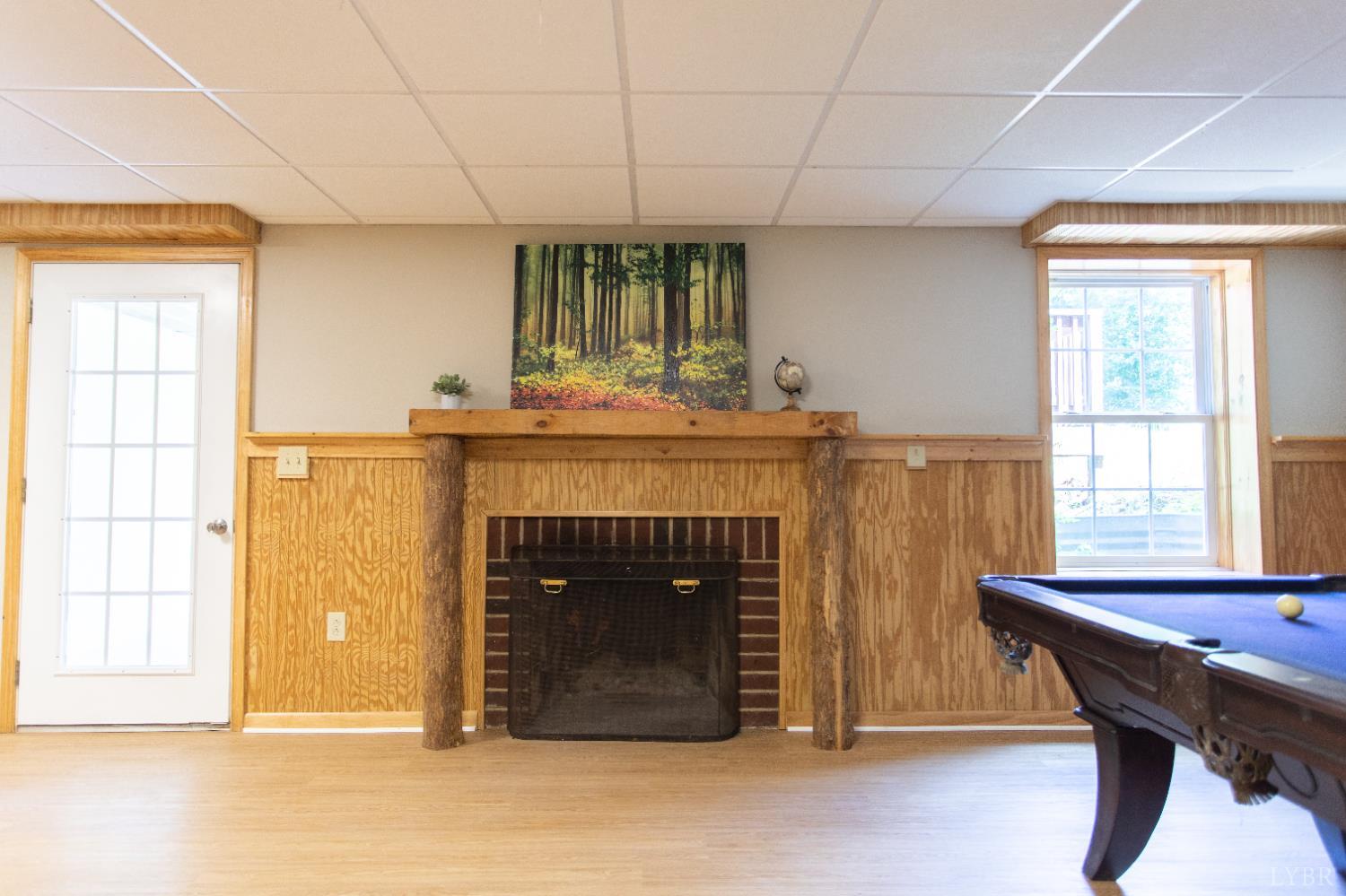 549 Thrashers Creek Road Amherst, VA 24521 - Photo 41 of 66 a living room with a table and a fireplace