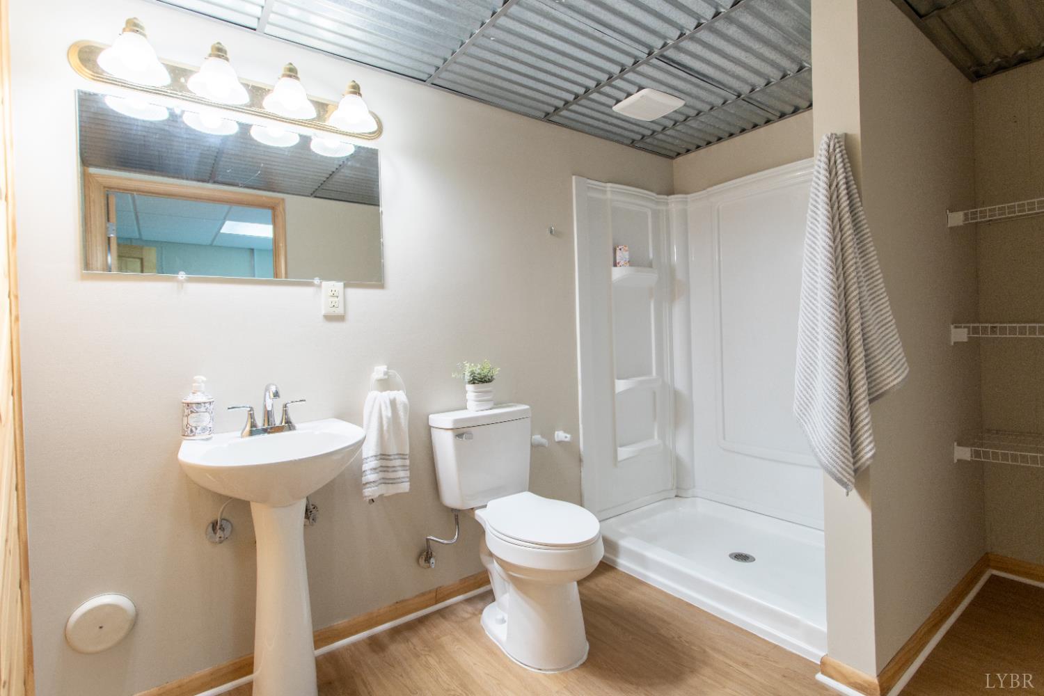 549 Thrashers Creek Road Amherst, VA 24521 - Photo 43 of 66 a bathroom with a sink mirror toilet and shower