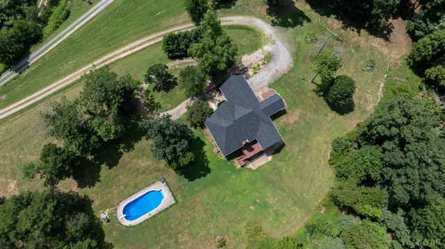 an aerial view of a house with yard swimming pool and outdoor seating
