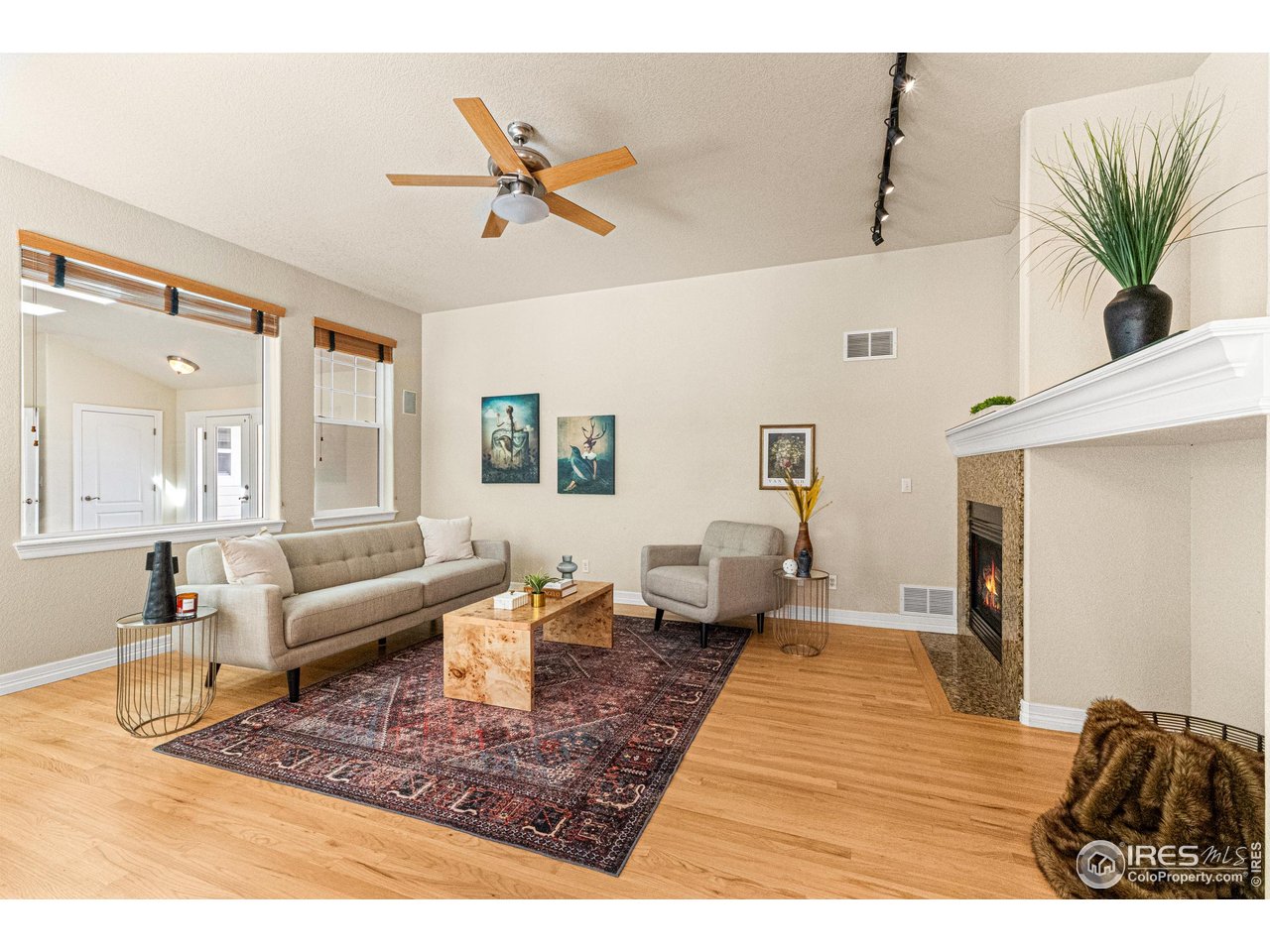 6495 Eagle Shadow Avenue Brighton, CO 80602 - Photo 12 of 40 a living room with furniture and a rug