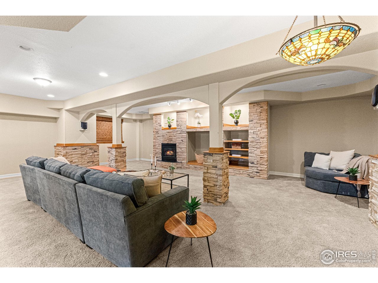 6495 Eagle Shadow Avenue Brighton, CO 80602 - Photo 24 of 40 a living room with furniture and a chandelier