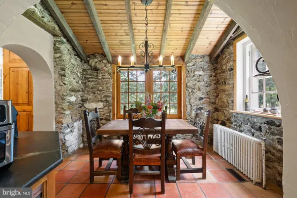 a view of a dining room with furniture a chandelier and wooden floor