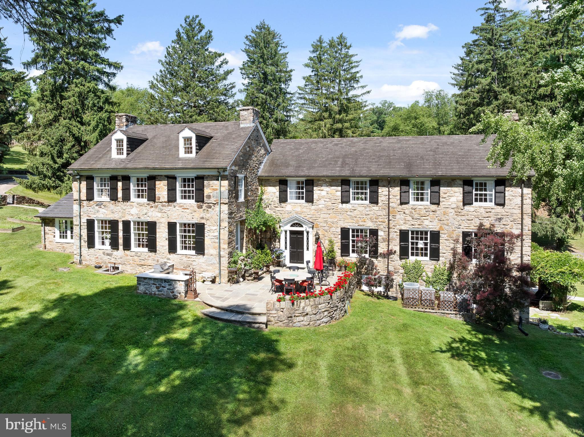 1740 Lenape Road West Chester, PA 19382 - Photo 4 of 91 a front view of a house with a garden and trees
